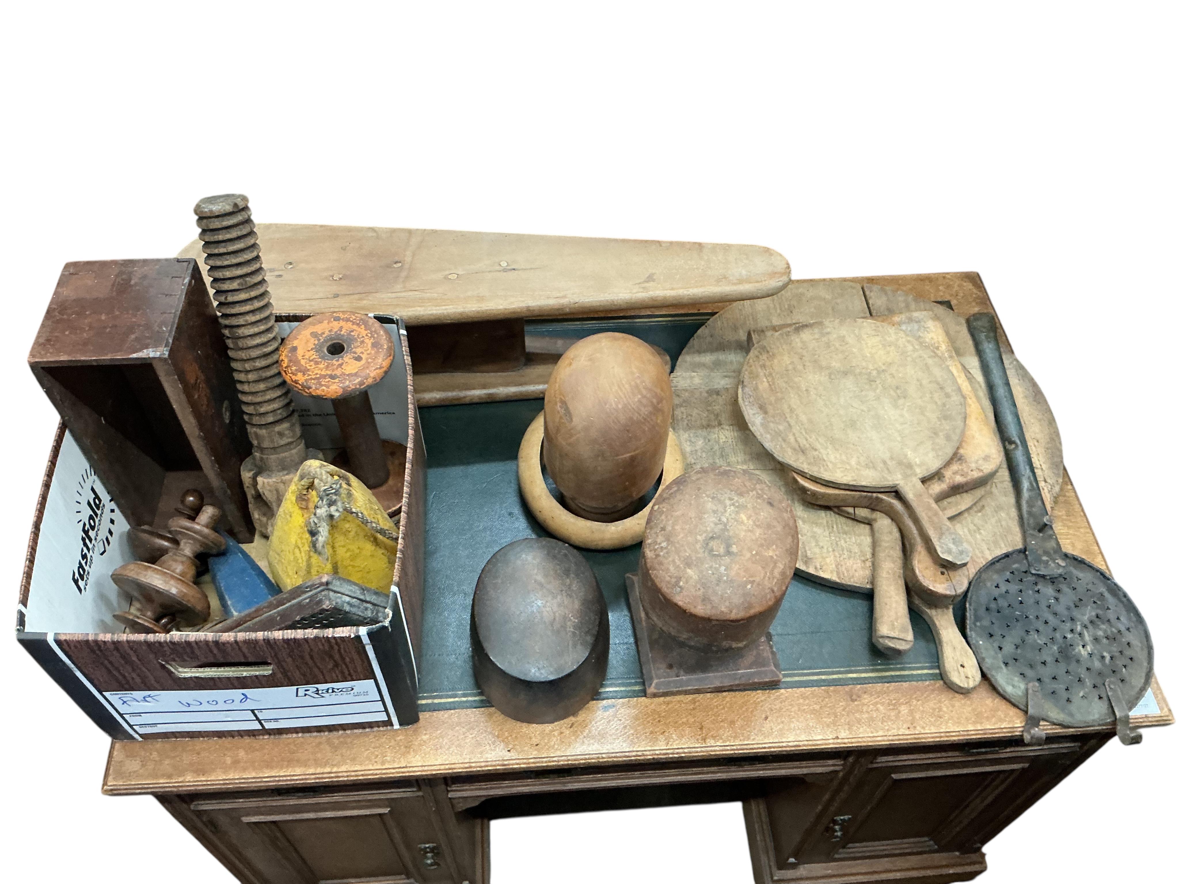 A quantity of assorted 19th century and later treen, chopping boards, hat moulds, etc.